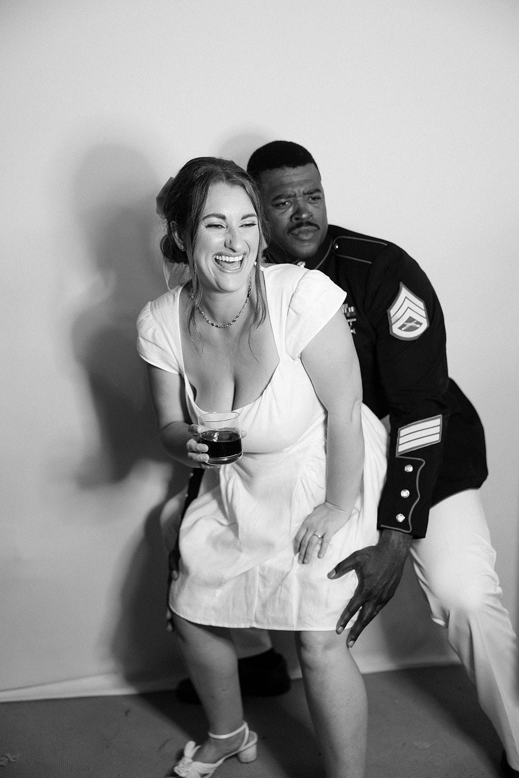 bride and groom pose in photobooth, candid portrait. Spring, private home tented wedding in south carolina. Sarah Bradshaw Photography