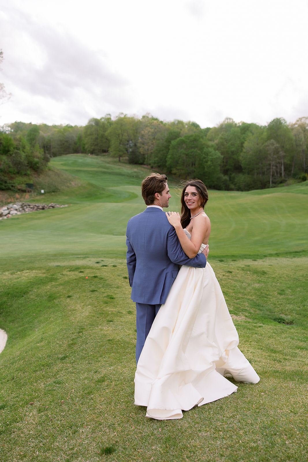 candid portrait of bride and groom on golf course. elegant spring wedding south carolina. sarah bradshaw photography