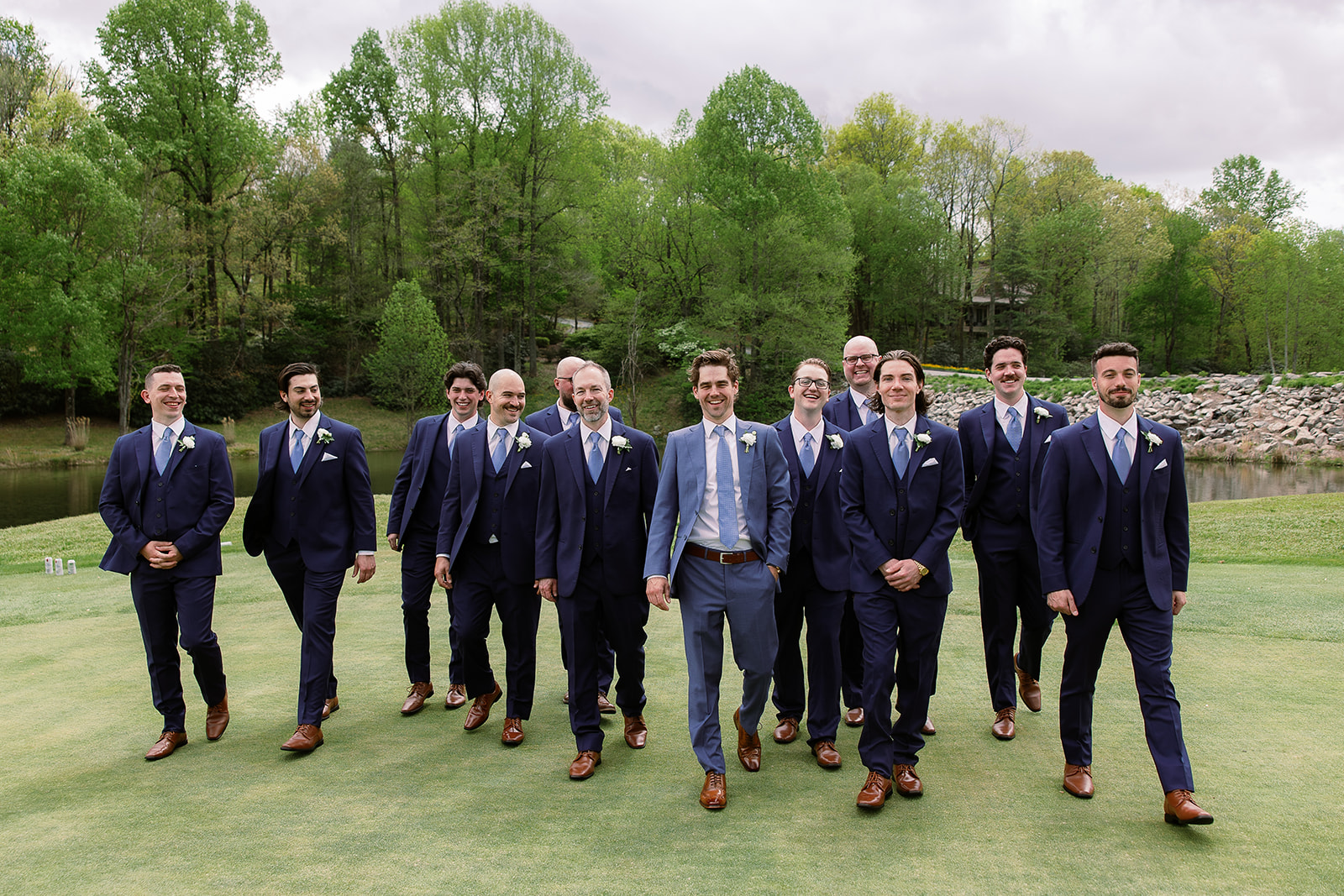 candid groom and groomsmen portrait, walking on golf course. elegant south carolina spring wedding. sarah bradshaw photography