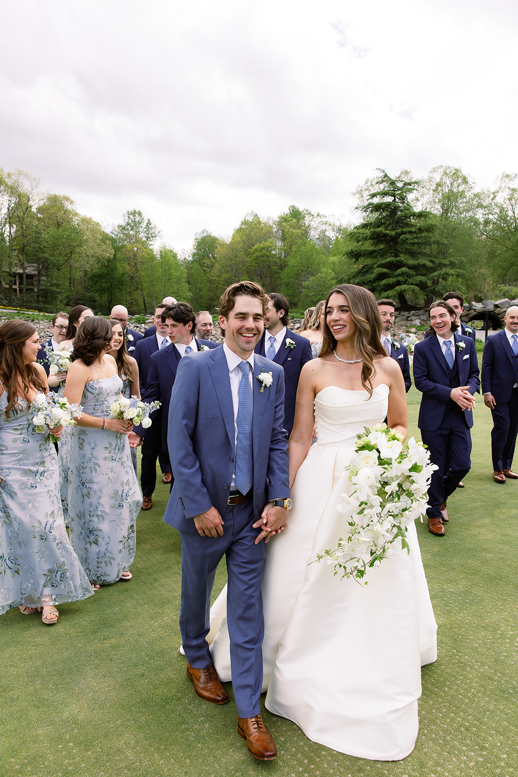 bride and groom walking portrait in front of wedding party on golf course. elegant south carolina spring wedding. sarah bradshaw photography