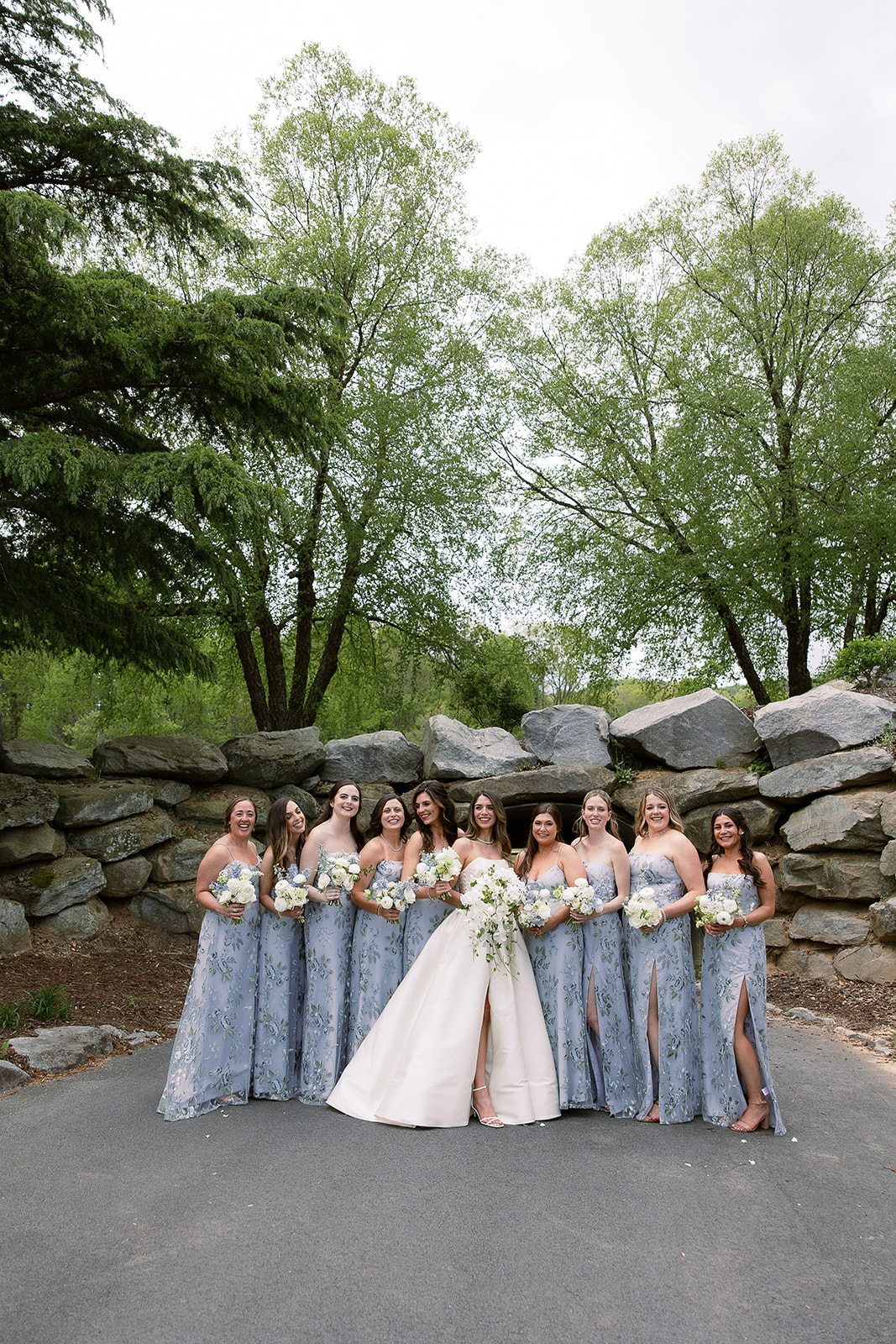 traditional bridal party portrait. bride in strapless ball gown wedding dress, bridesmaids in floral printed dresses. elegant south carolina spring wedding. sarah bradshaw photography
