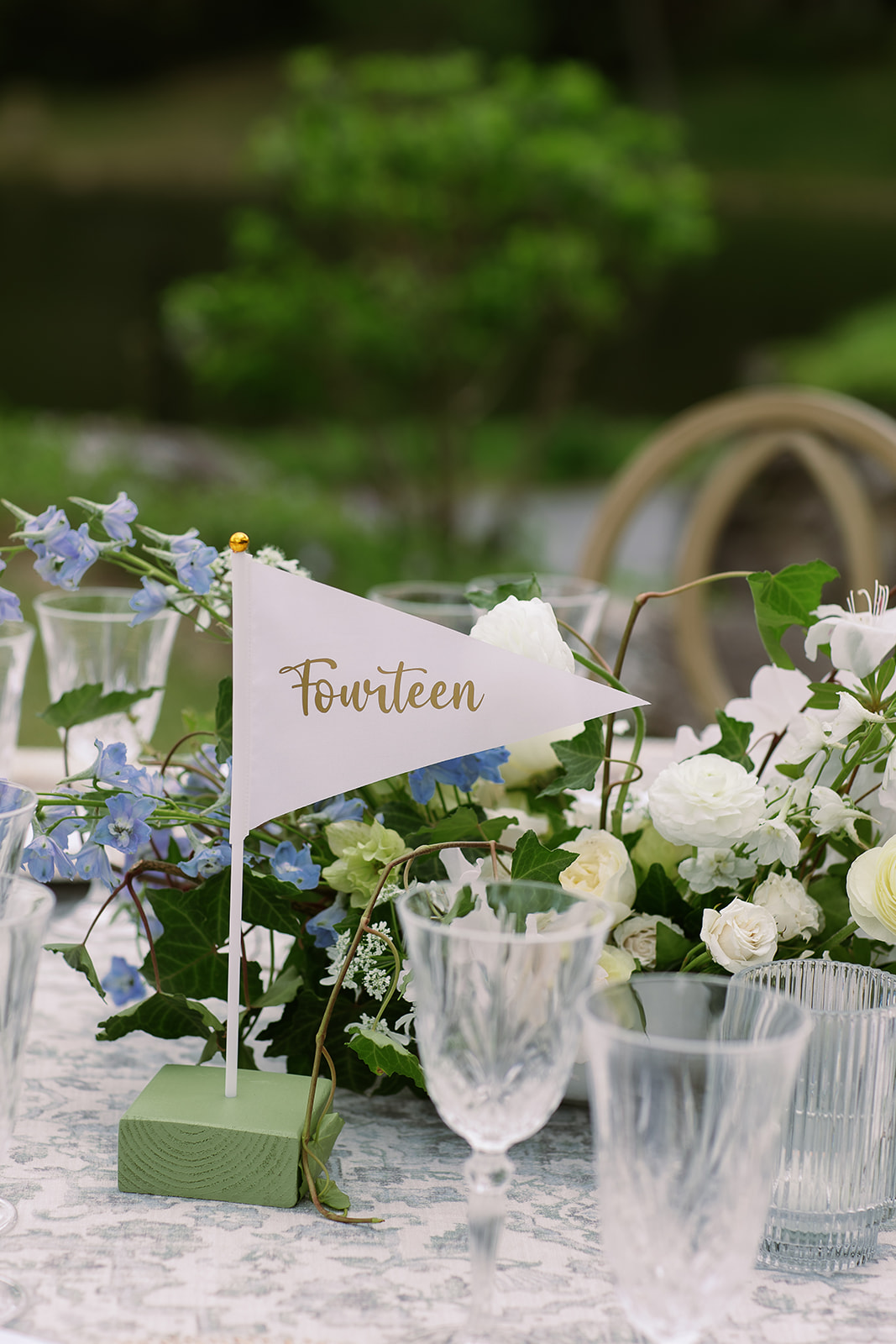 Golf flag inspired wedding table numbers, lush blue and white floral centerpieces. elegant south carolina spring wedding. sarah bradshaw photography