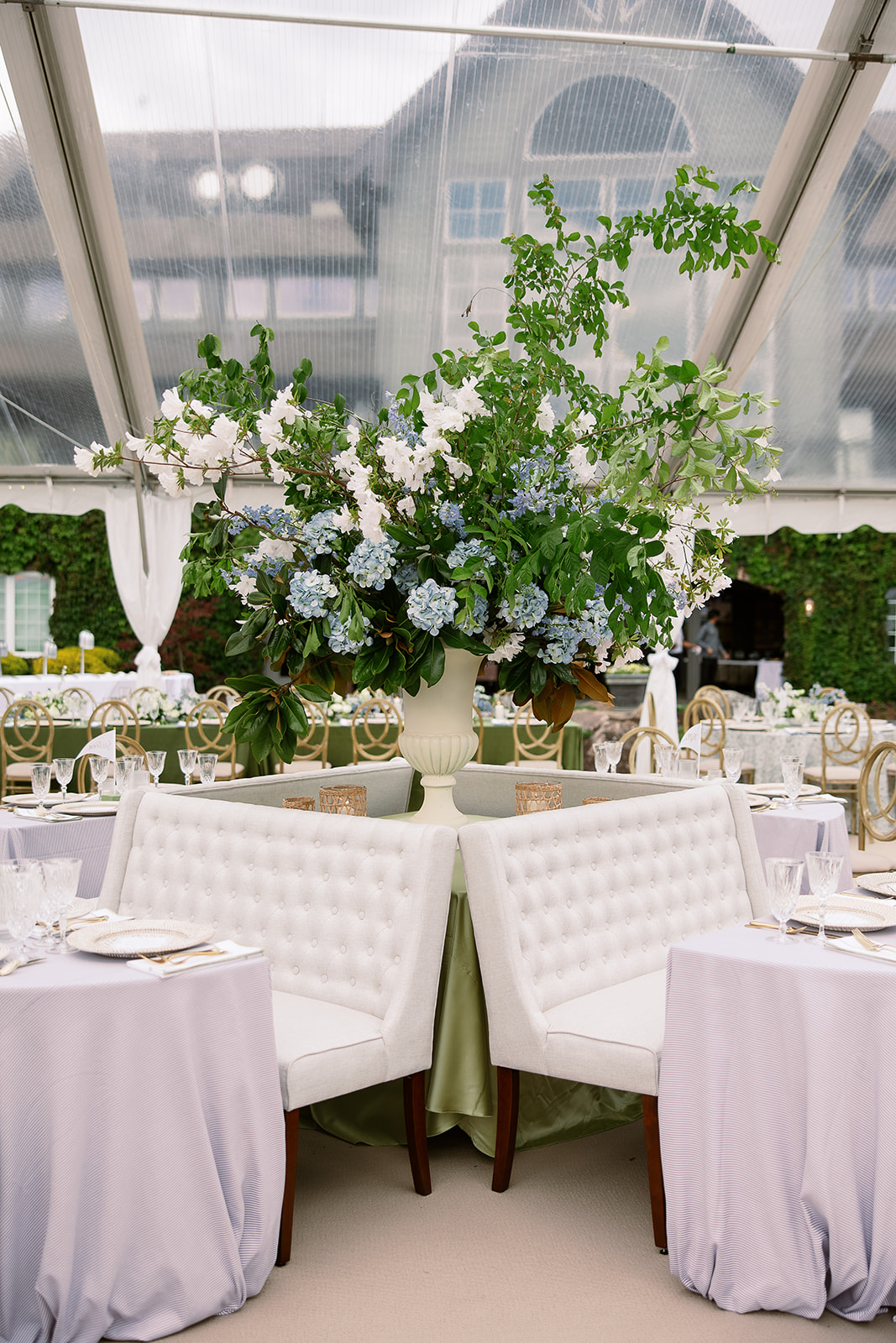 Creative cocktail hour lounge seating. Blue floral large centerpiece. elegant south carolina spring wedding. sarah bradshaw photography