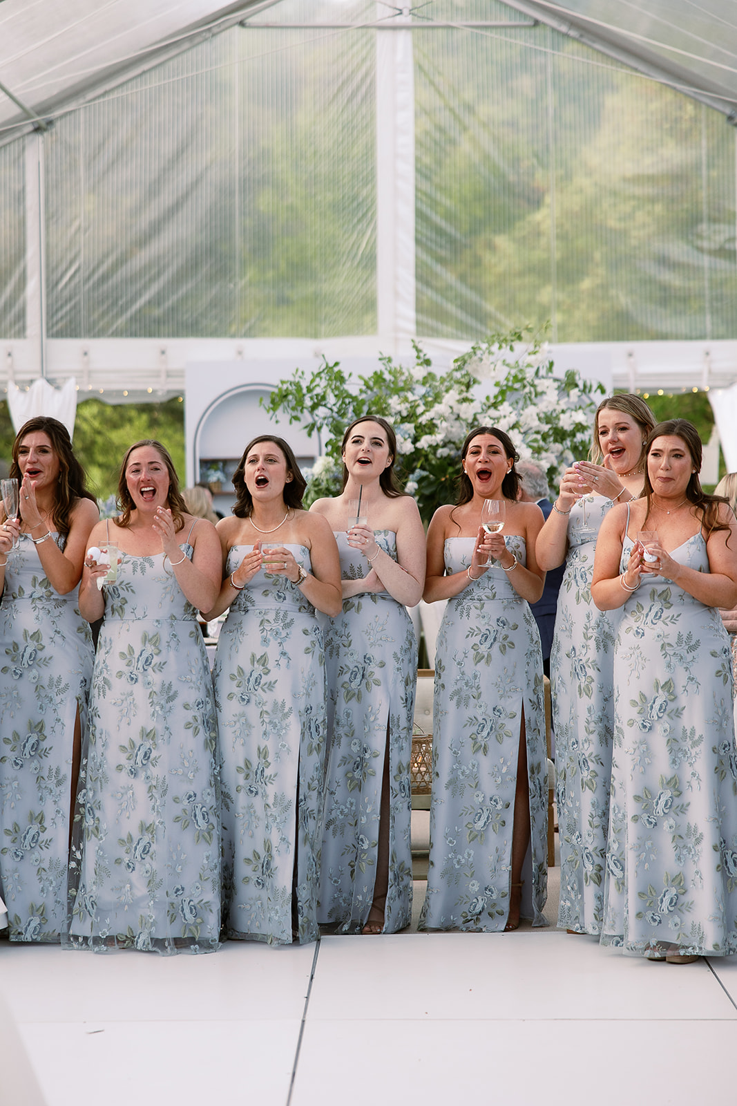 bridesmaids celebrate in blue floral printed dresses. elegant south carolina spring wedding. sarah bradshaw photography