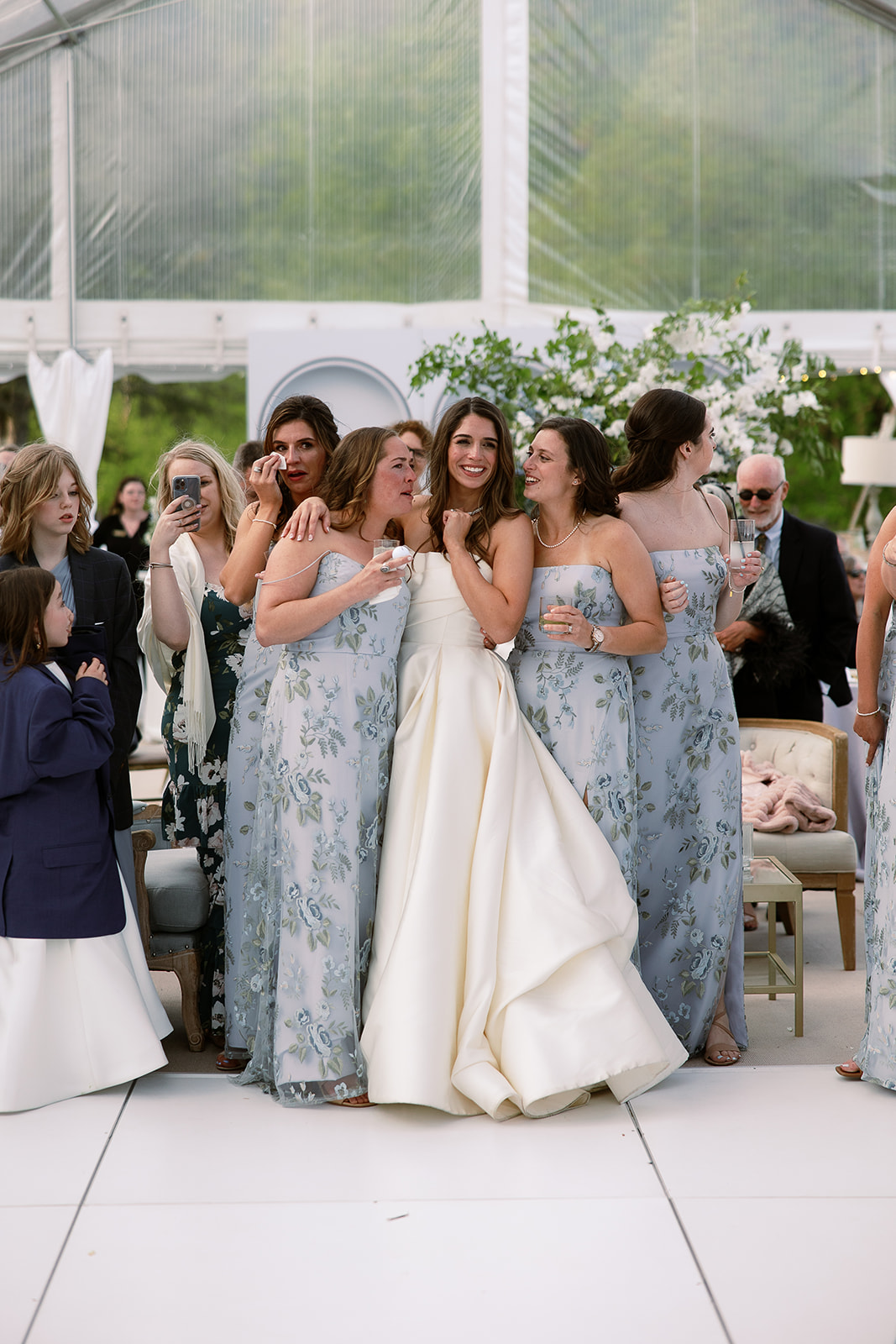 bride hugs bridesmaids during groom and mother dance. elegant south carolina spring wedding. sarah bradshaw photography
