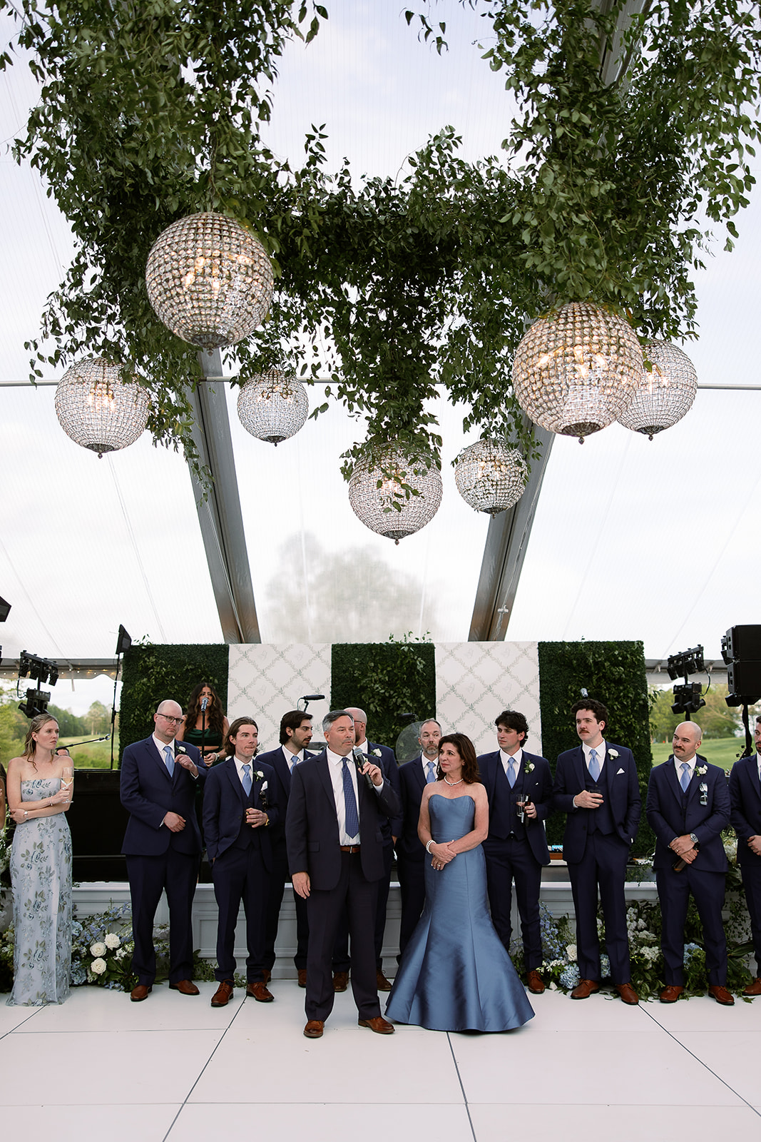 parents speech during wedding reception. hanging greenery in tent. elegant south carolina spring wedding. sarah bradshaw photography