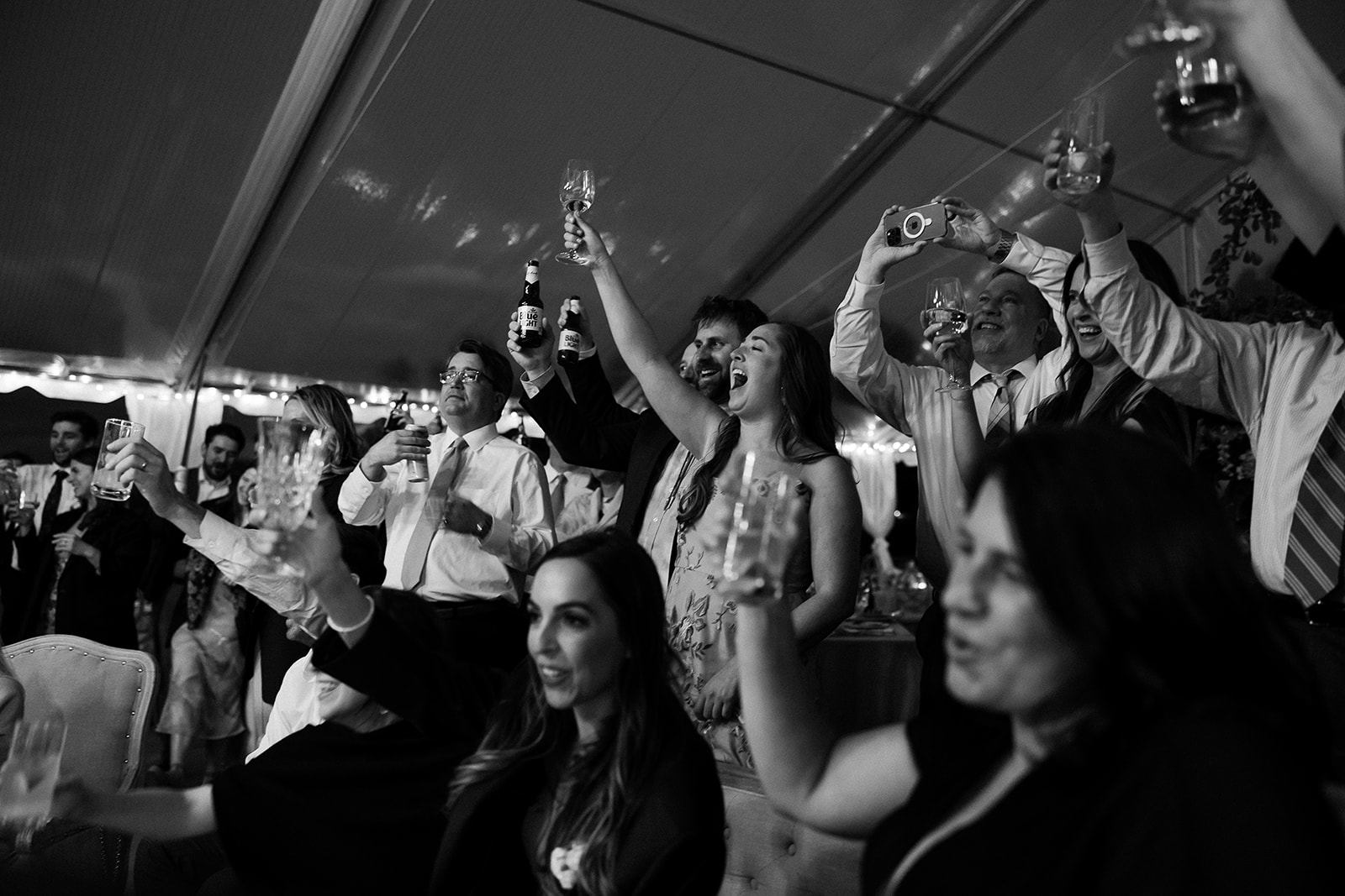 wedding guests cheers and toast during wedding reception. elegant south carolina spring wedding. sarah bradshaw photography
