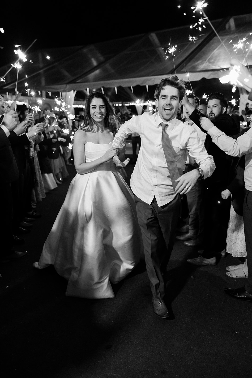 bride and groom run through wedding sparkler exit. elegant south carolina spring wedding. sarah bradshaw photography