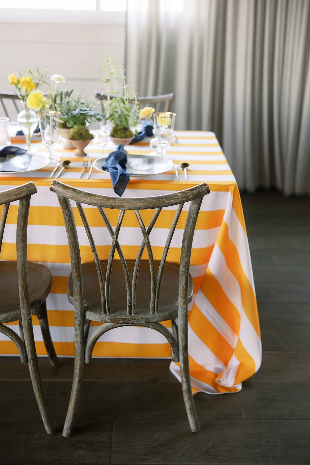 Lemon and white striped table linen. Rustic wooden chairs.  Italian inspired wedding rehearsal dinner in Greenville, SC. Sarah Bradshaw Photography