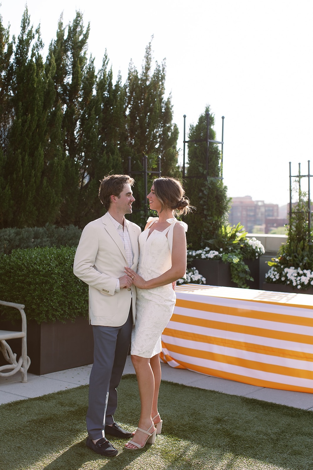 Rooftop terrace portrait of bride and groom at rehearsal dinner.  Italian inspired wedding rehearsal dinner in Greenville, SC. Sarah Bradshaw Photography