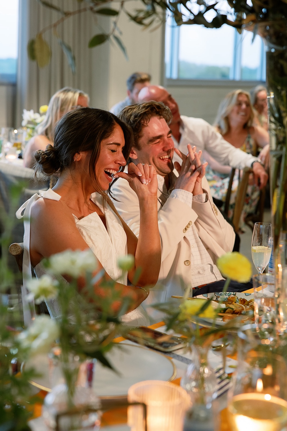 Bride and groom laugh at rehearsal dinner speeches.  Italian inspired wedding rehearsal dinner in Greenville, SC. Sarah Bradshaw Photography