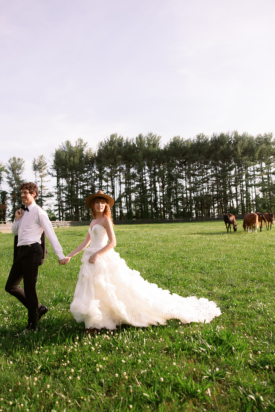 creative wedding portrait, bride and groom walking in horse farm. chic equestrian wedding inspiration at Red Fox Inn, Middleburg Virginia. Sarah Bradshaw