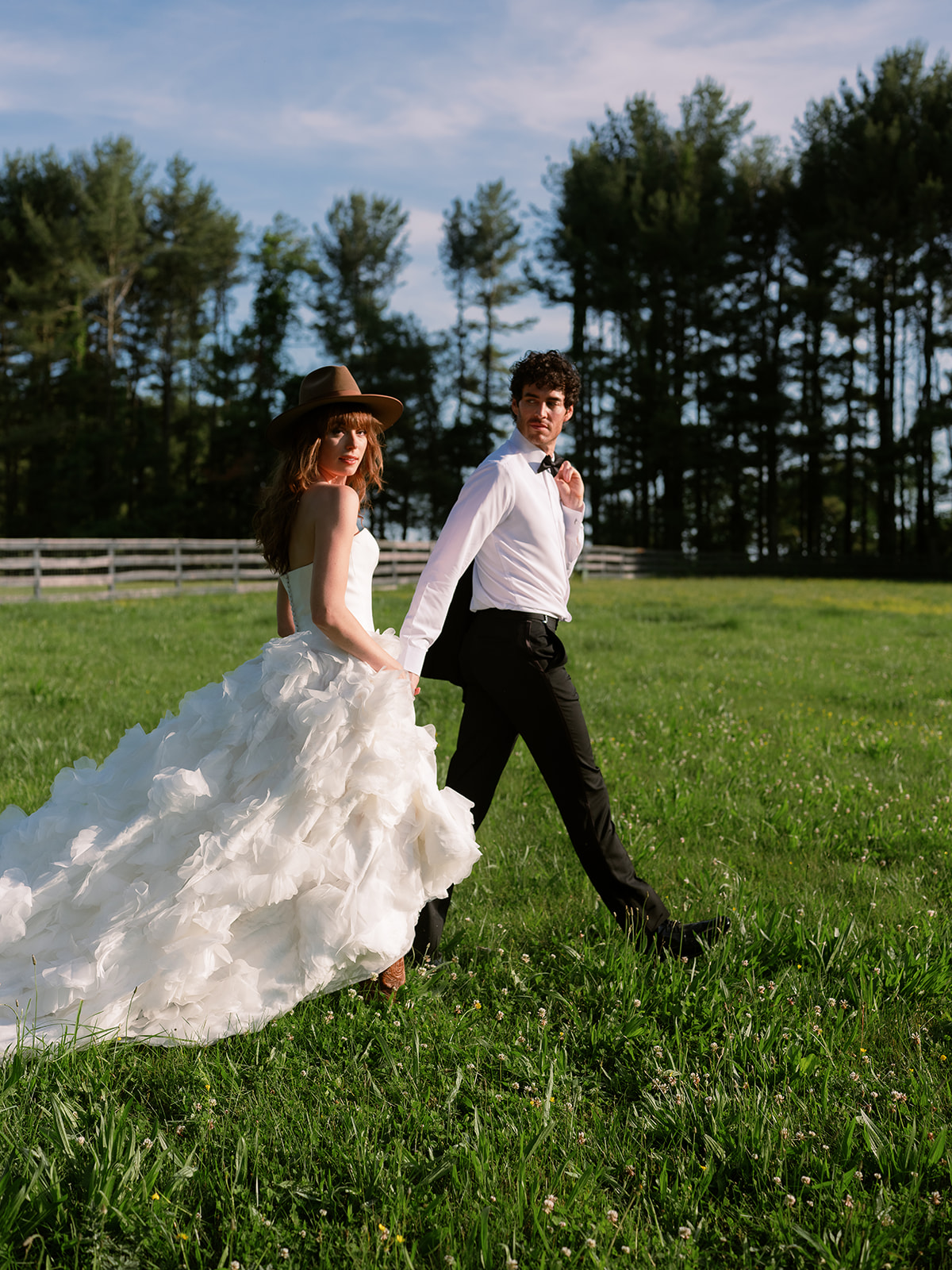 candid portrait of bride and groom walking on horse farm. chic equestrian wedding inspiration at Red Fox Inn, Middleburg Virginia. Sarah Bradshaw