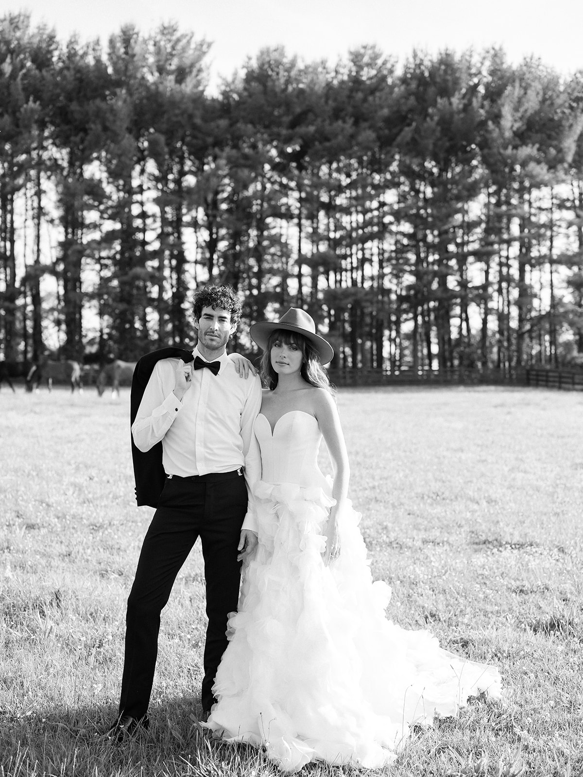 black and white wedding day portrait on farm. bride in tulle skirt strapless wedding dress. chic equestrian wedding inspiration at Red Fox Inn, Middleburg Virginia. Sarah Bradshaw