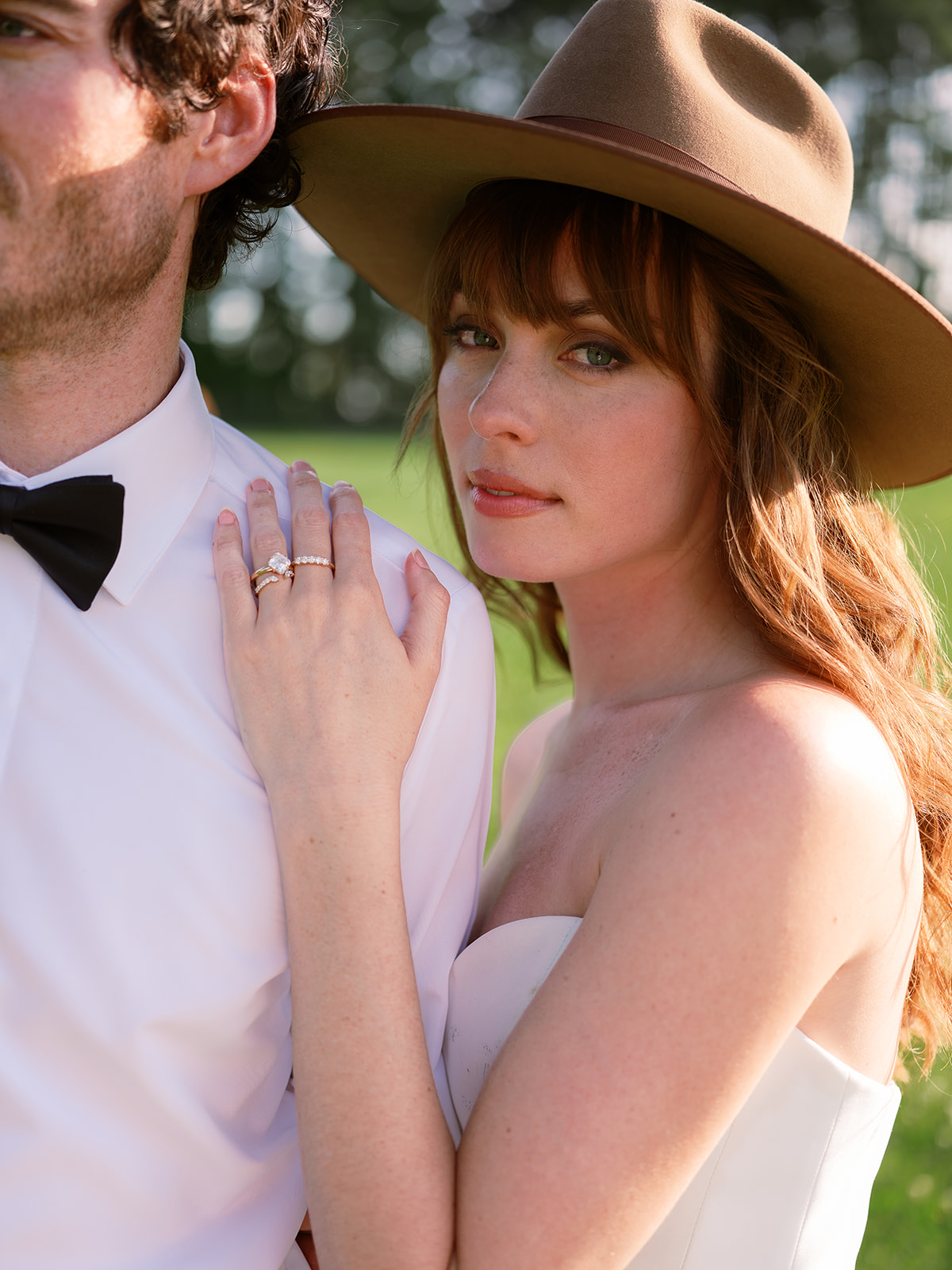 close up portrait of bride in strapless dress wearing a hat. chic equestrian wedding inspiration at Red Fox Inn, Middleburg Virginia. Sarah Bradshaw