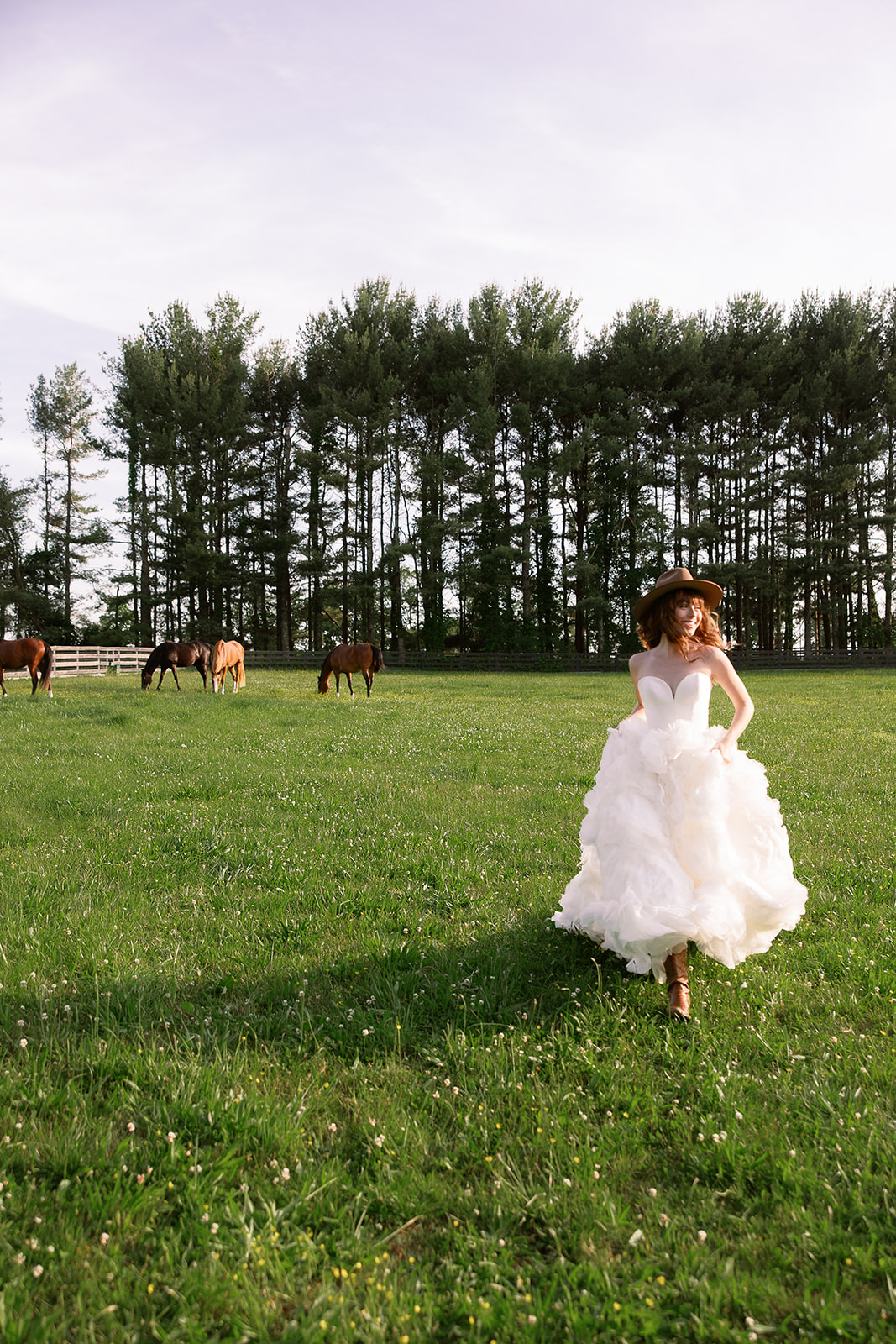 portrait of bride running in horse field on farm estate. chic equestrian wedding inspiration at Red Fox Inn, Middleburg Virginia. Sarah Bradshaw