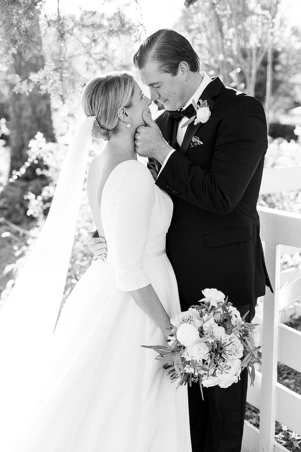 black and white portrait of groom holding bride's face, about to kiss. Classic timeless winter wedding, woodlawn manor, alexandria va. Sarah bradshaw photography