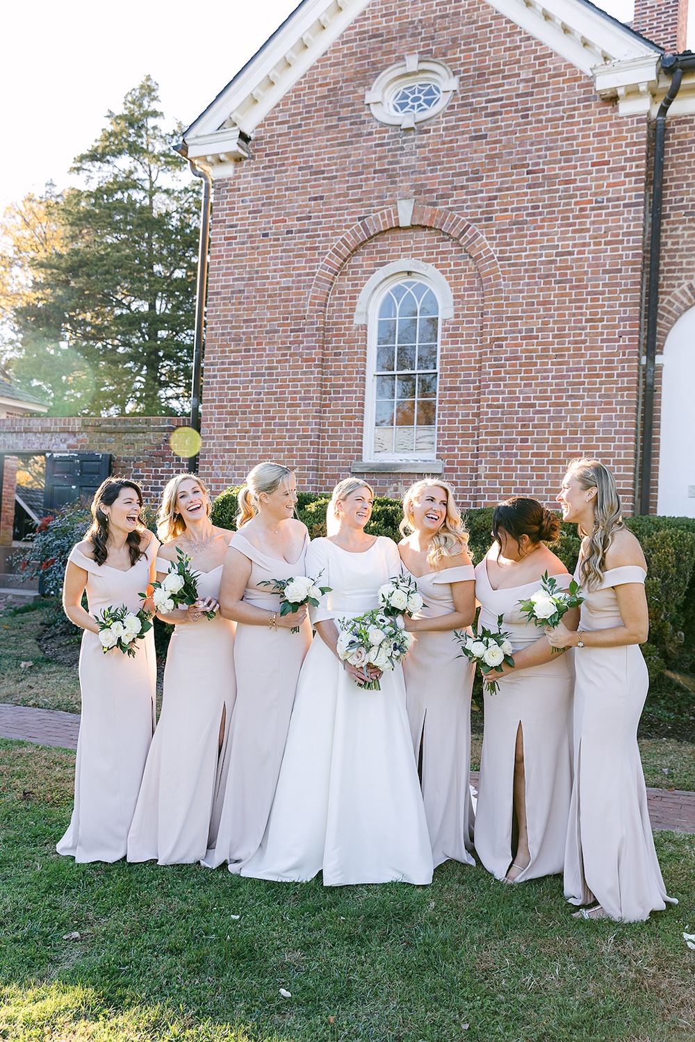 bridal party portrait of bride and bridesmaids laughing. bridesmaids in light pink dresses. Classic timeless winter wedding, woodlawn manor, alexandria va. Sarah bradshaw photography