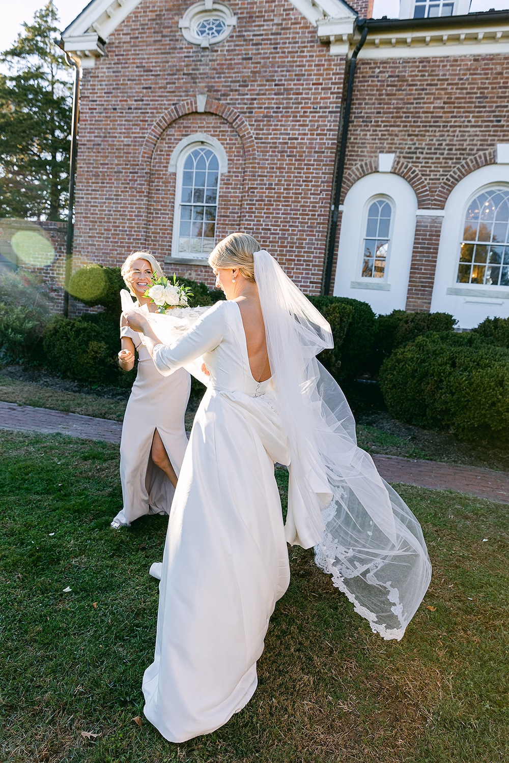 bride's long lace trimmed wedding veil blows in the wind. Classic timeless winter wedding, woodlawn manor, alexandria va. Sarah bradshaw photography