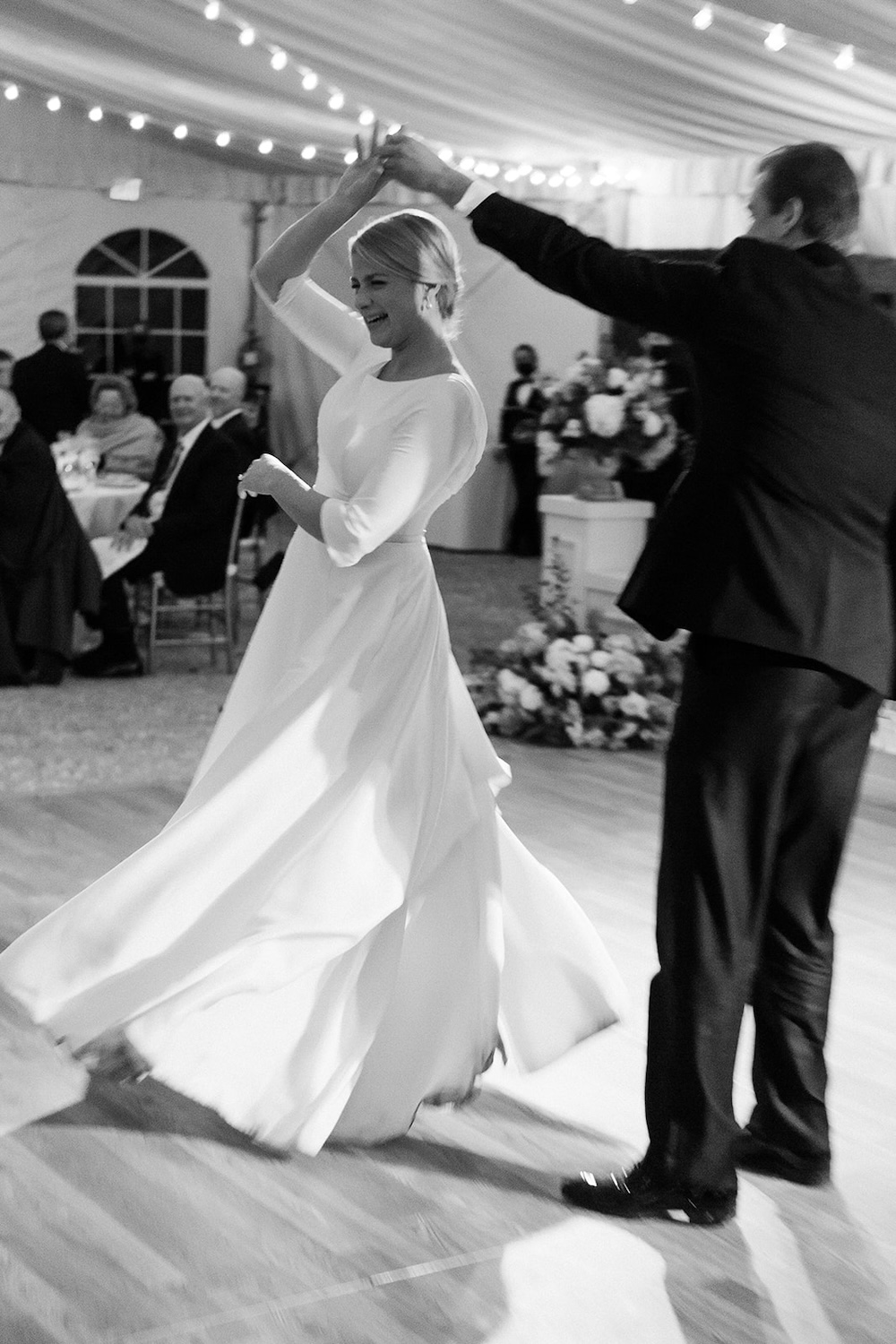 black and white photo of groom twirling bride during first dance. Classic timeless winter wedding, woodlawn manor, alexandria va. Sarah bradshaw photography