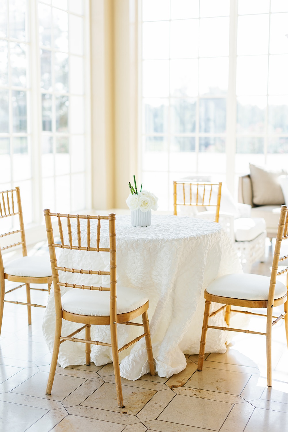 Simple white and gold cocktail hour seating. Small white roses centerpiece with bamboo accent. Modern Luxe Washington DC wedding, Sarah Bradshaw Photography