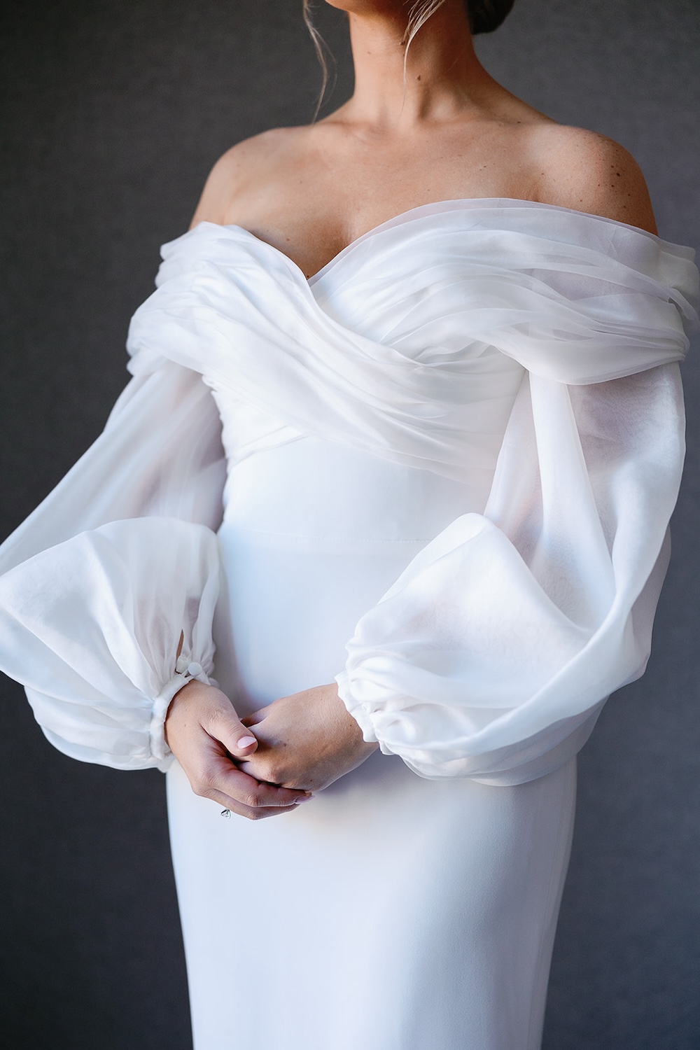 close up bridal portrait, designer wedding dress. ruched bodice, off shoulders long sleeves. High end hotel ballroom wedding, The Fairmont, Washington DC. Sarah Bradshaw Photography