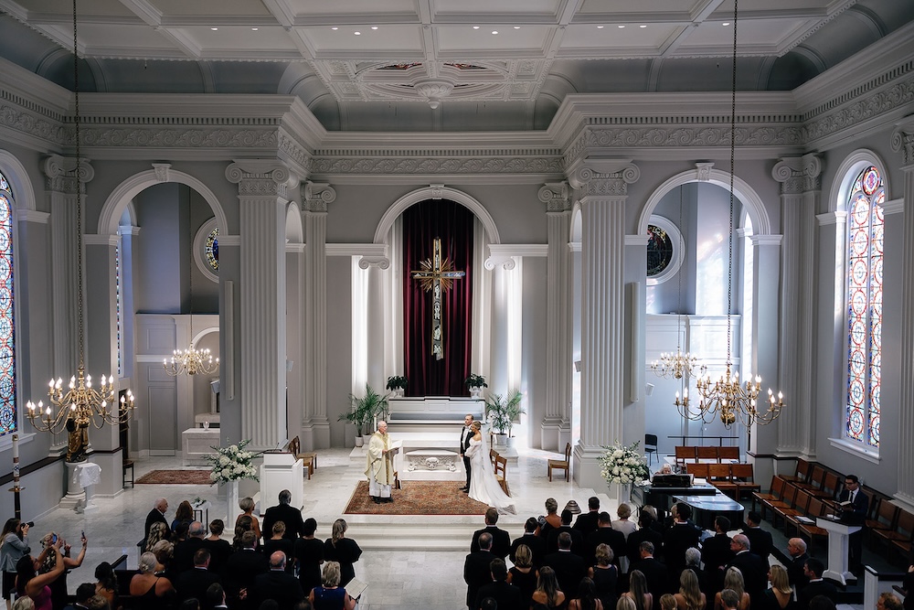 bride and groom exchange vows in cathedral. High end hotel ballroom wedding, The Fairmont, Washington DC. Sarah Bradshaw Photography