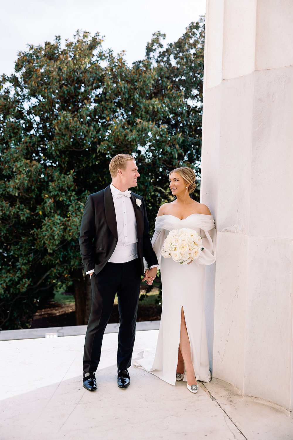 bride and groom at Lincoln Memorial. designer wedding dress with off shoulders long sleeves. High end hotel ballroom wedding, The Fairmont, Washington DC. Sarah Bradshaw Photography