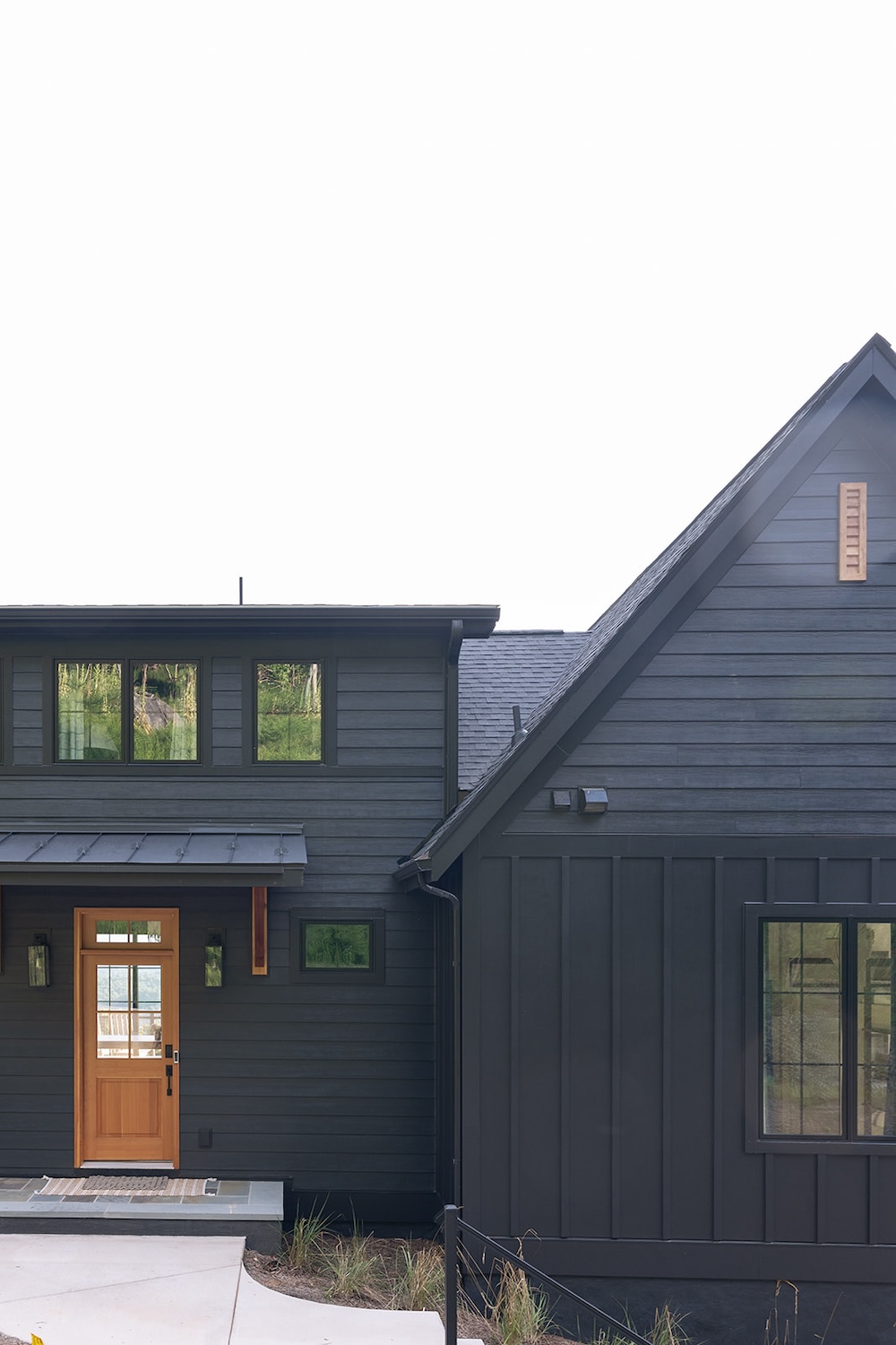 View of front door, black painted home. Luxury rental property in blue ridge mountains, afton house, sarah bradshaw photography.