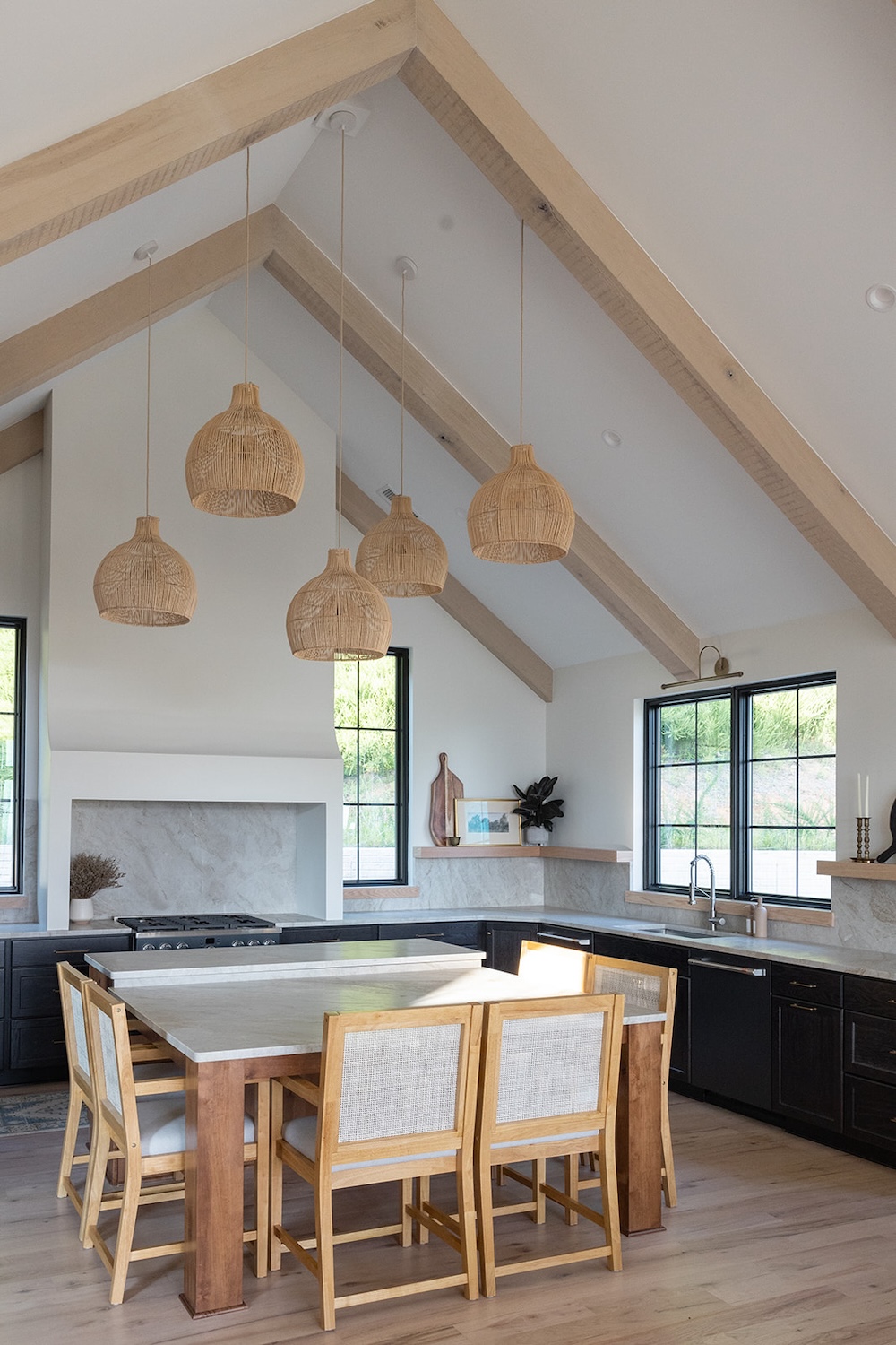 rustic modern kitchen, rattan hanging lighting fixtures, light and airy. Luxury rental property in blue ridge mountains, afton house, sarah bradshaw photography.