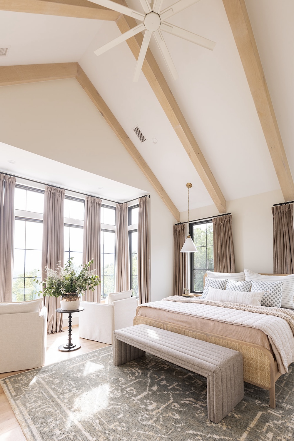 seating area in primary bedroom suite, wood beams, modern neutrals. Luxury rental property in blue ridge mountains, afton house, sarah bradshaw photography.