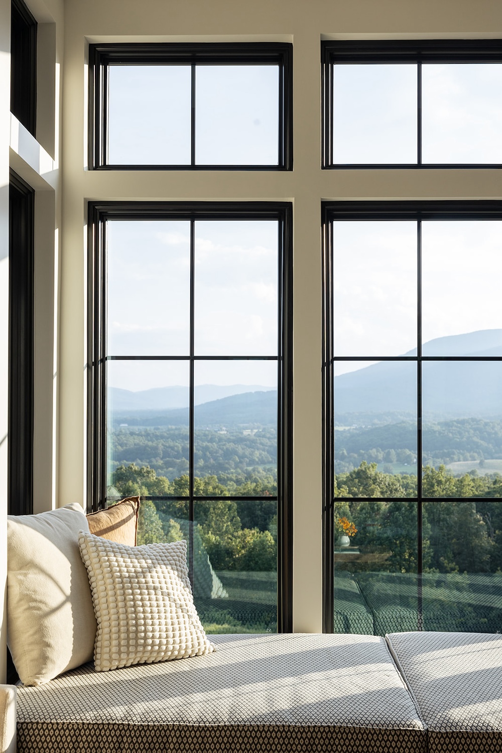 window bench seating, wall to wall windows. Luxury rental property in blue ridge mountains, afton house, sarah bradshaw photography.