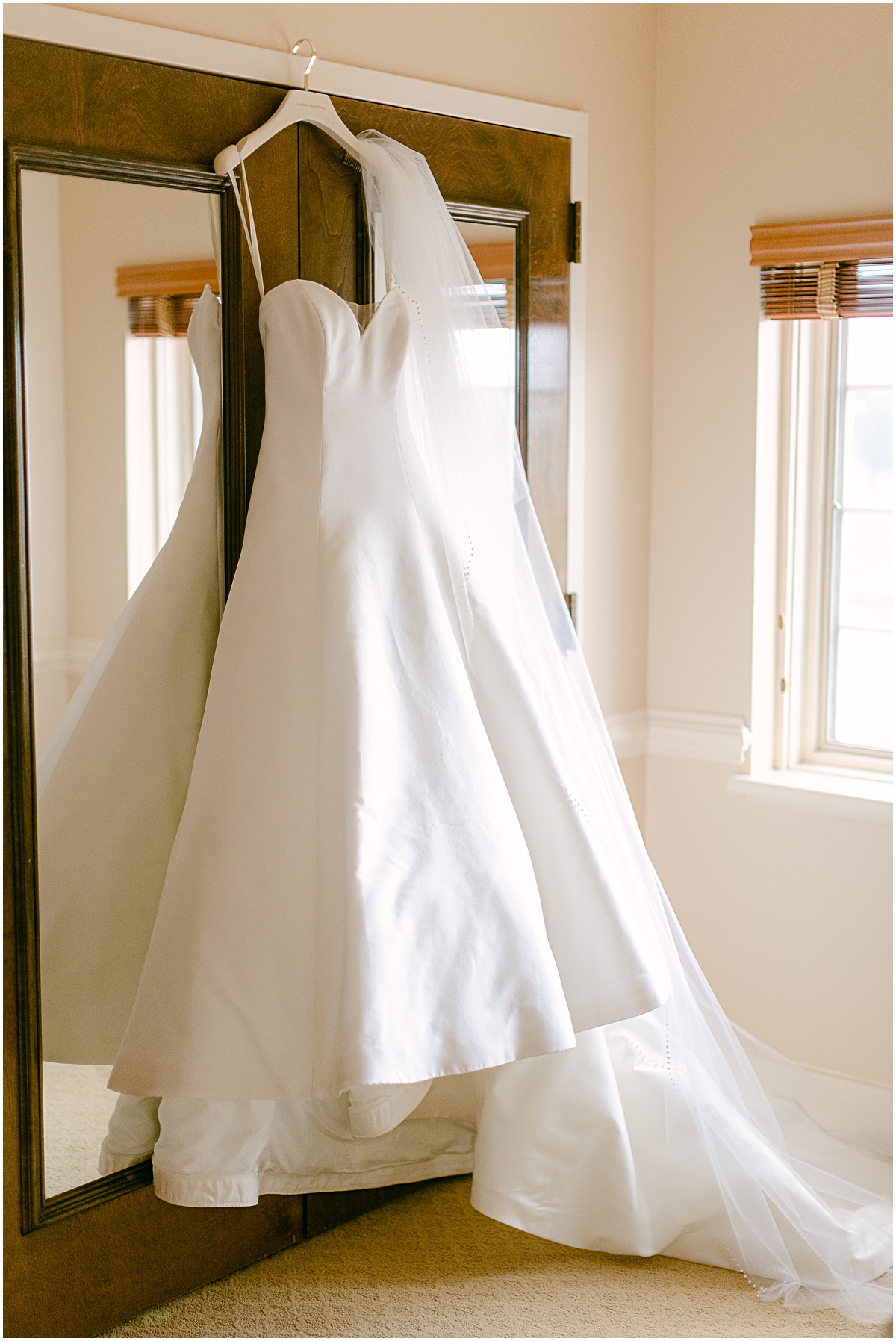 Wedding gown hanging in suite at Congressional Country Club wedding by Sarah Bradshaw