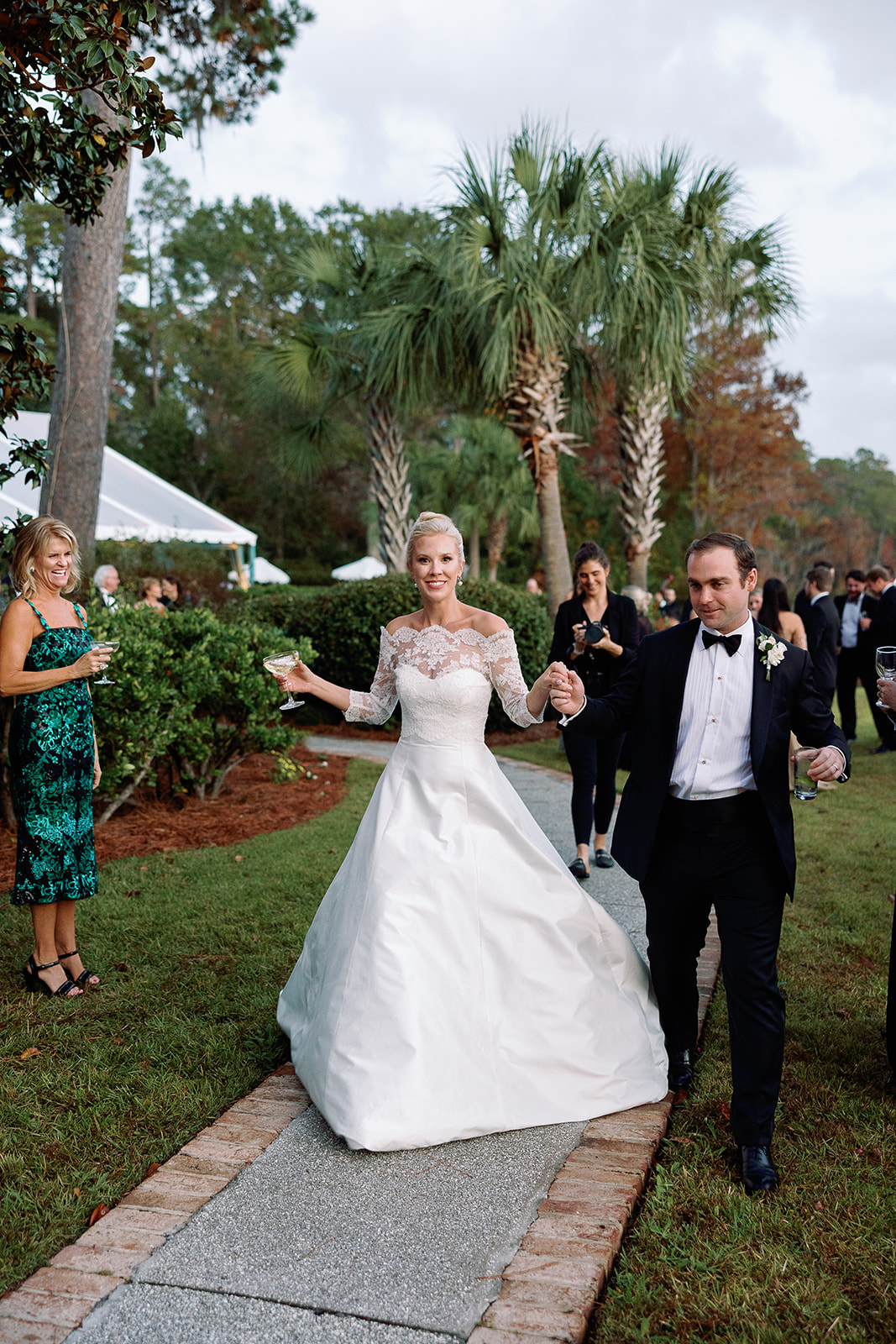 Bride and groom enter wedding reception at private home. Classic Black Tie wedding in Georgetown, SC. Sarah Bradshaw Photography