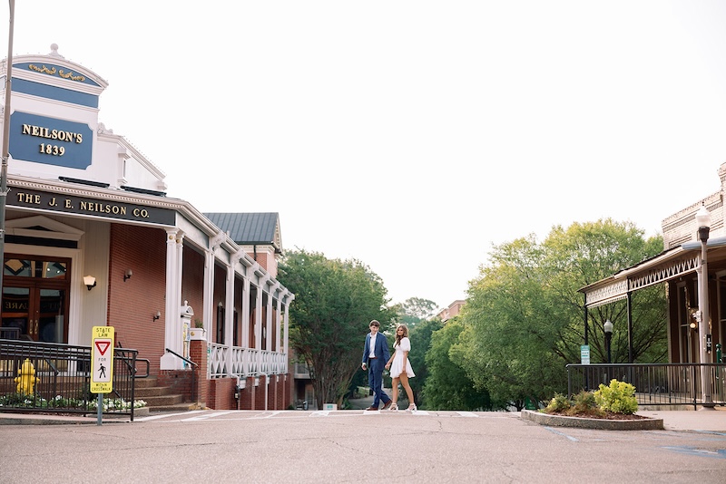 portrait of couple crossing small town street. southern wedding engagement session, sarah bradshaw photography.