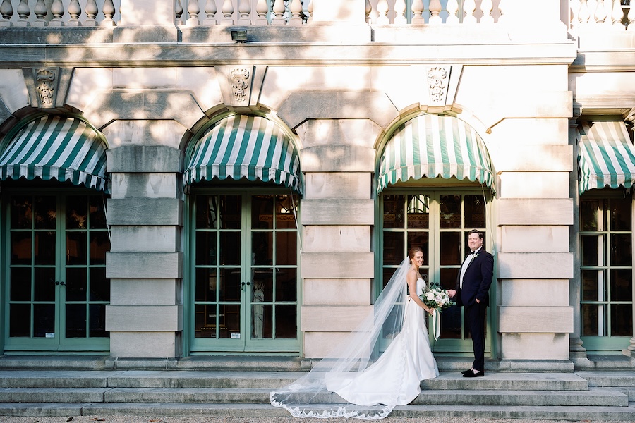 bride and groom pose in front of historic home. timeless black tie, winter wedding in washington, dc. anderson house. sarah bradshaw photography