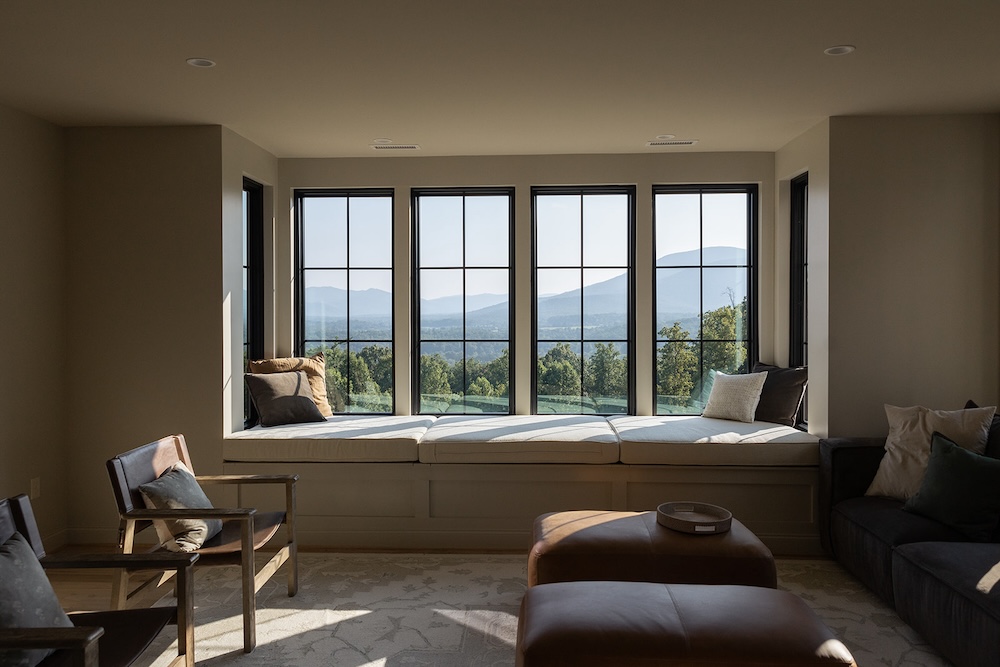 masculine living room space, modern minimalist. cozy window bench seat. Luxury rental property in blue ridge mountains, afton house, sarah bradshaw photography.