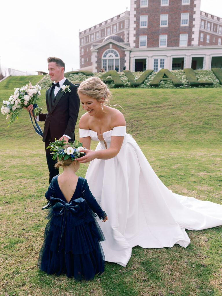 bride helping flower girl at Historic Cavalier Hotel in Virginia Beach by Sarah Bradshaw Photography